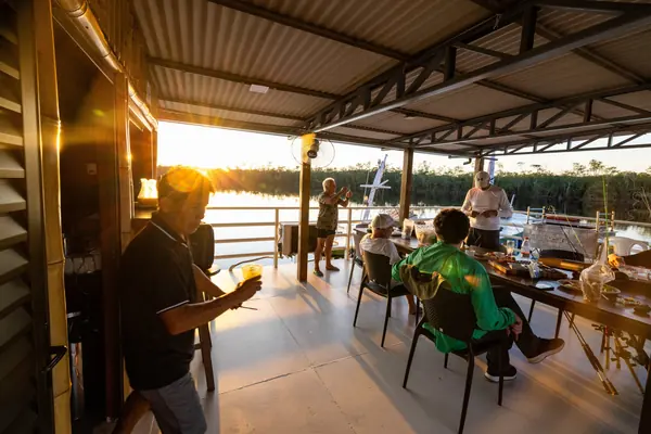 Anglers and guides at the table on the lodge deck